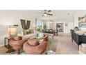 Cozy living room leading to a dining area, filled with natural light and stylish furniture at 4911 Schubert Trl, North Port, FL 34287