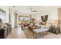 Bright living room featuring neutral decor, stylish furnishings, and sliding glass doors to patio at 5028 Schubert Trl, North Port, FL 34287