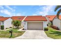 Charming home featuring a 2-car garage, well-maintained lawn, and beautiful landscaping for curb appeal at 5046 San Rocco Ct, Punta Gorda, FL 33950