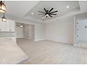 Spacious, airy room features modern flooring, a shiplap accent wall, and a ceiling fan, perfect for comfortable living at 7149 Sea Mist Dr, Port Charlotte, FL 33981