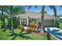 Inviting single-story home with lush landscaping, palm trees, and a well-maintained front lawn at 7505 Carissa, Punta Gorda, FL 33955