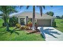 Beautiful single-story home with lush landscaping, vibrant plants, and a spacious two-car garage at 7505 Carissa, Punta Gorda, FL 33955