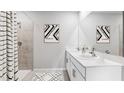 Bright bathroom featuring a double sink vanity, modern fixtures, and a walk-in shower at 9474 Turtle Grass Cir, Punta Gorda, FL 33950