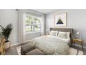 Cozy bedroom showcasing a patterned duvet, bright window, and complementary decor at 9474 Turtle Grass Cir, Punta Gorda, FL 33950
