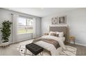 Comfortable bedroom with a large window, stylish decor, and neutral tones at 9474 Turtle Grass Cir, Punta Gorda, FL 33950