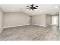 Spacious living area with gray vinyl floors, neutral paint, and recessed lighting offering a bright and airy feel at 16031 Hesta Misty Ct, Punta Gorda, FL 33955