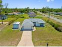 Charming single-story home with a well-maintained lawn, two car garage, and a separate storage shed at 1981 Arena Ln, North Port, FL 34286