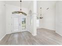 Bright foyer with cathedral ceilings, modern gray flooring, and elegant hanging light fixtures at 2168 Calcutta Rd, Punta Gorda, FL 33983