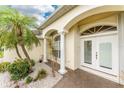 Close up of the columned entrance with a double door, with manicured plants and decorative gravel at 2168 Calcutta Rd, Punta Gorda, FL 33983