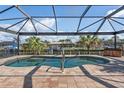 Screened-in spa with dock and canal views, perfect for relaxation and enjoying the waterfront lifestyle at 2526 Rio Plato Dr, Punta Gorda, FL 33950