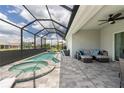 Inviting screened-in lanai with a pool, hot tub, and comfortable seating area, perfect for outdoor relaxation at 25308 Rupert Rd, Punta Gorda, FL 33983