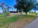 Charming home with well-manicured lawn and mature trees in a tranquil neighborhood at 27193 And 27197 Voyageur Dr, Punta Gorda, FL 33983