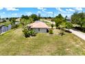 Spacious lot with lush lawn backing onto the canal, situated in a peaceful residential area at 27193 And 27197 Voyageur Dr, Punta Gorda, FL 33983