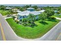Corner lot featuring a home with a metal roof and landscaped yard, situated in a neighborhood with mature trees at 329 W Grace St, Punta Gorda, FL 33950