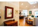 Inviting foyer with hardwood floors, decorative mirror, and hall table leading to the living spaces at 329 W Grace St, Punta Gorda, FL 33950