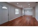 Bright living room featuring new laminate floors, neutral paint, and plenty of natural light from large window at 406 Merlin Ct, Brandon, FL 33510