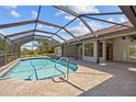 Screened-in pool with stone patio and views of backyard at 501 Fairmont Ter, Port Charlotte, FL 33954