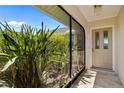 Covered lanai featuring lush greenery, privacy, and a tiled floor at 69 Bunker Rd, Rotonda West, FL 33947