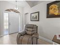 Inviting foyer with tiled floors, and a comfortable looking recliner next to the front door at 7448 S Blue Sage, Punta Gorda, FL 33955