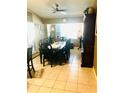 Formal dining room featuring tile flooring, ceiling fan, and natural light at 1017 Guild St, Port Charlotte, FL 33952