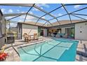 Inviting screened-in pool area with comfortable lounge seating, perfect for relaxation and outdoor entertainment at 111 Britt Rd, Rotonda West, FL 33947