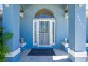 Inviting front entrance with decorative security door, side windows, and cute dog statues at 12185 Weimar Ave, Port Charlotte, FL 33981