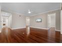 Open living room with gleaming hardwood floors, ceiling fan, recessed lighting, and neutral paint palette at 143 Tropicana Dr # 1012, Punta Gorda, FL 33950
