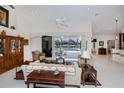 Spacious living room with tile flooring, ceiling fan, and sliding glass doors to the pool at 1435 Pine Island Ct, Punta Gorda, FL 33950