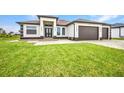 Stunning single-story home featuring a three-car garage and well-kept lawn at 15 Tournament Rd, Rotonda West, FL 33947