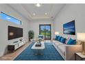 Bright living room with modern decor, a large window, and access to the outdoor area at 15 Tournament Rd, Rotonda West, FL 33947