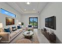 Bright living room with modern decor, large windows, and access to the outdoor area at 15 Tournament Rd, Rotonda West, FL 33947