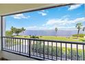 Balcony overlooking manicured grounds and waterfront, offering stunning views at 1500 Park Beach Cir # 2F, Punta Gorda, FL 33950