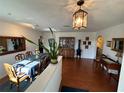 Bright dining room with wood floors, classic chandelier, and elegant decor at 1505 Kenmore St, Port Charlotte, FL 33952