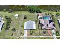 Aerial view of home, adjacent lot, and canal showing proximity and nearby homesites at 1596 Hayworth Rd, Port Charlotte, FL 33952