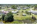 Neighborhood aerial showing home's location relative to street, neighboring houses, and waterway at 1596 Hayworth Rd, Port Charlotte, FL 33952