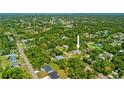 Aerial view of the property showcasing the surrounding neighborhood, lush greenery, and serene atmosphere at 17396 Cox Ave, Port Charlotte, FL 33948