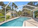 Relaxing screened-in pool area with comfortable seating and a charming pool house for outdoor enjoyment at 17396 Cox Ave, Port Charlotte, FL 33948