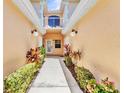 Condo entrance with walkway, decorative shrubs, and inviting lighting at 206 Gondola Park Dr # 206, Venice, FL 34292