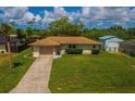 Charming single story house with a well-kept lawn and inviting curb appeal at 2119 Pellam Blvd, Port Charlotte, FL 33948