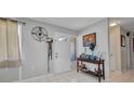 Bright foyer with tiled flooring, a console table, and an entryway with a glass accented door at 2465 Deedra St, Port Charlotte, FL 33952