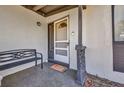 Inviting front porch featuring decorative columns, a bench, a welcome mat, and a screen door at 2465 Deedra St, Port Charlotte, FL 33952