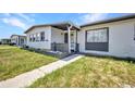 Close up view of a one story home featuring nice landscaping and a walkway to the entrance at 2465 Deedra St, Port Charlotte, FL 33952