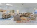 Bright living room with tile floors, skylights, and comfortable seating at 2521 W Marion Ave # 912, Punta Gorda, FL 33950