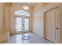 Welcoming foyer featuring decorative tile, double front doors, and ample natural light creating an inviting entrance at 25538 Rampart Blvd, Punta Gorda, FL 33983