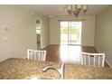 Open-concept living room with wood floors and sliding glass doors to the screened-in porch at 26430 Rampart Blvd # 511, Punta Gorda, FL 33983