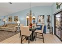 Bright dining area with a modern chandelier, seating for four, and easy access to the lanai at 3225 Magnolia Way, Punta Gorda, FL 33950