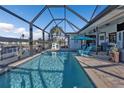 Covered pool with clear blue water, patio seating, and an outdoor living space at 3225 Magnolia Way, Punta Gorda, FL 33950