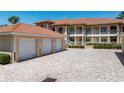 Lovely condominium exterior showcasing garages, well manicured landscape, and covered walkways at 3314 Wood Thrush Dr # 124, Punta Gorda, FL 33950