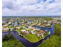 An aerial view of a waterfront community with houses surrounded by canals at 3518 Terin Ct, Punta Gorda, FL 33950