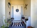 Cozy front porch with decorative elements, plants, and a welcoming bench at 4092 Troost St, North Port, FL 34288